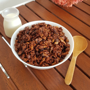 Granola with pumpkin seeds, almond and raisins generously coated with dark chocolate.