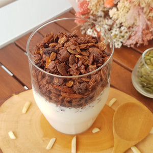Granola with pumpkin seeds, almond and raisins generously coated with dark chocolate. 